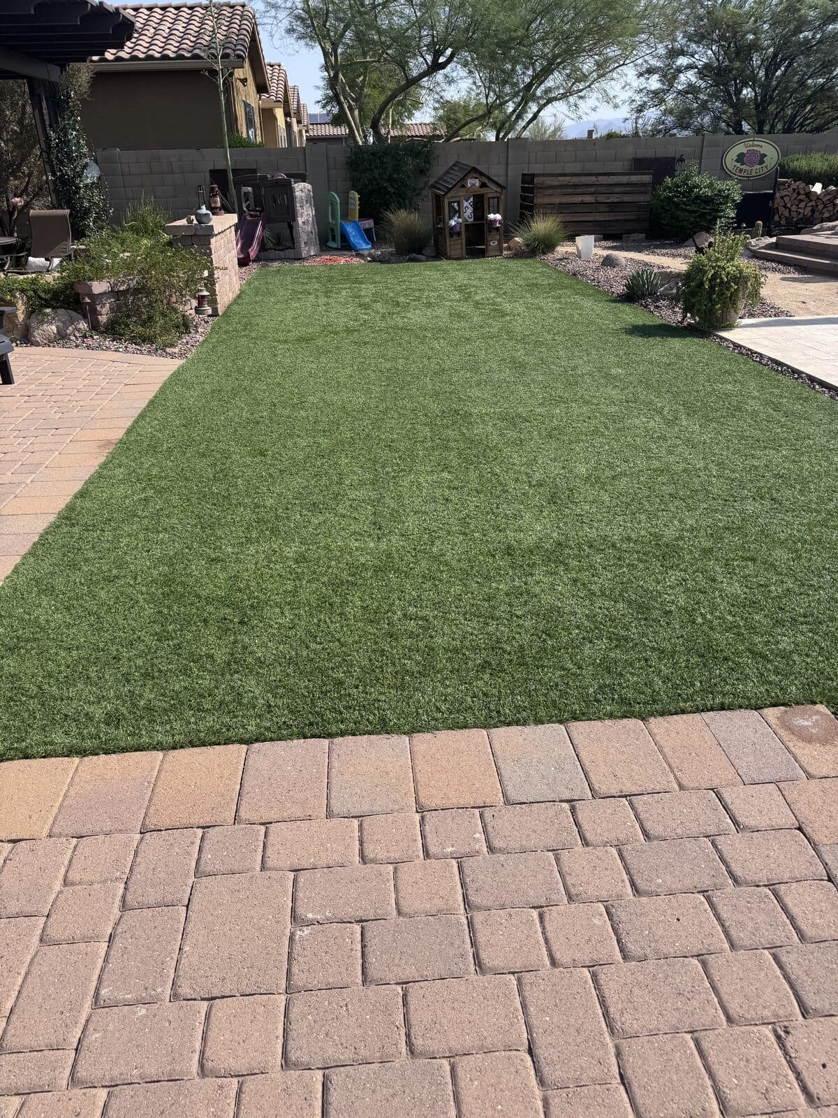 Beautiful freshly cleaned artificial turf backyard